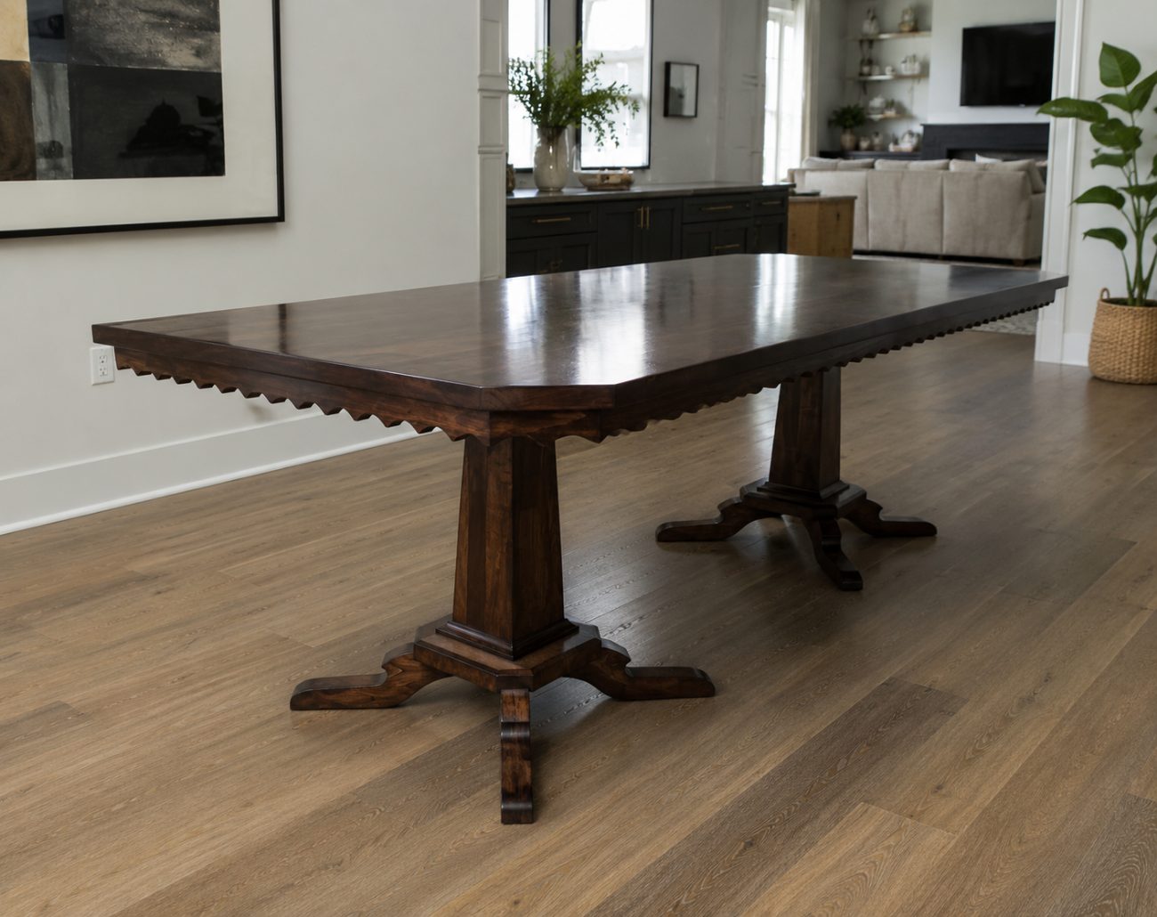 Handcrafted walnut double-pedestal dining table with a scalloped edge in a bright modern home